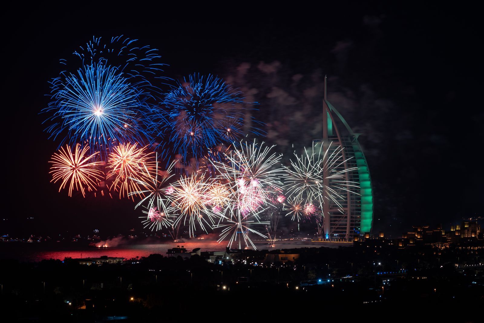 Fireworks over the Dubai coastline at night, the busiest evening for New Year's Eve event staff in Dubai