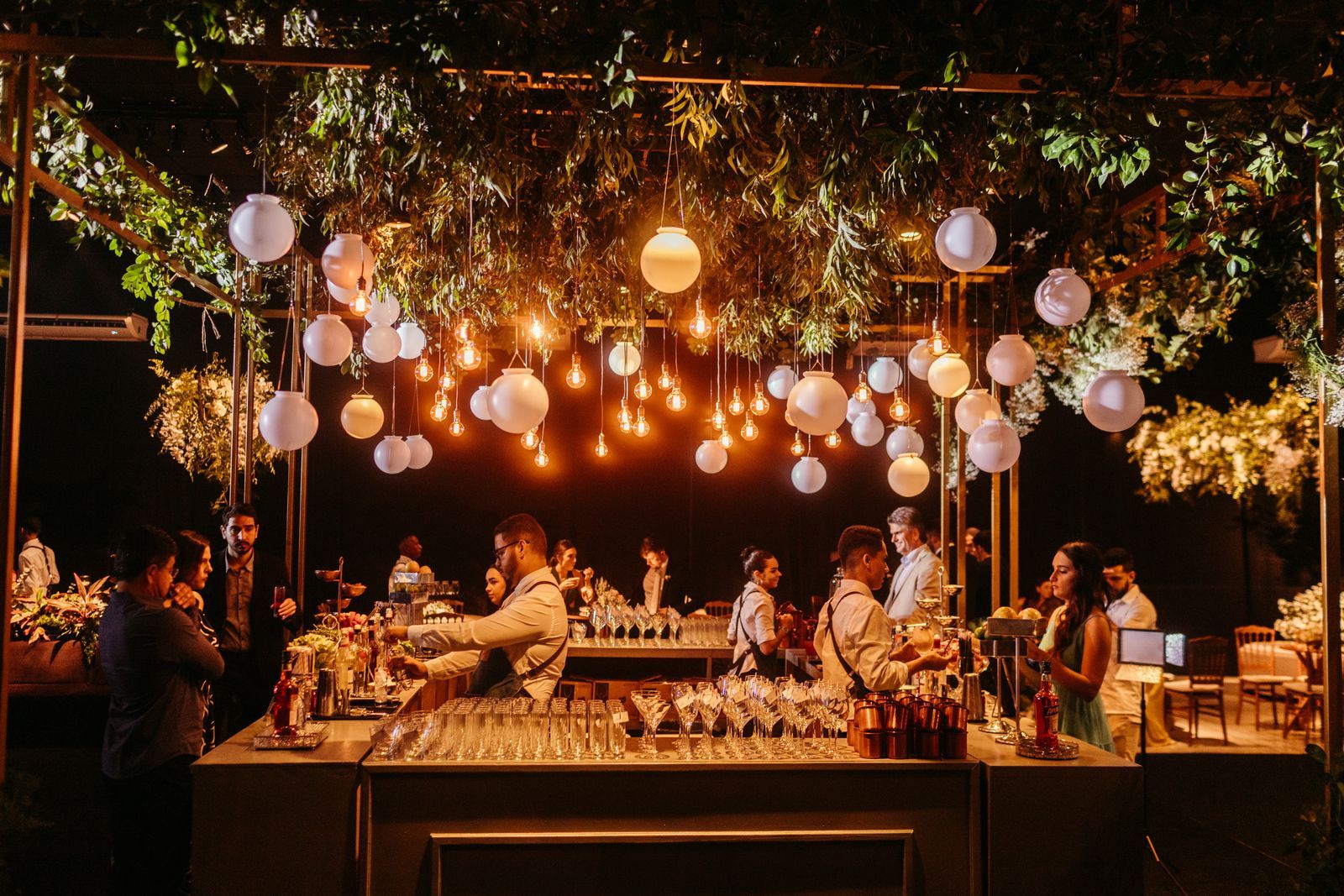 Evening reception with a decorated bar and hanging lanterns, ready for hostesses in Dubai to welcome guests
