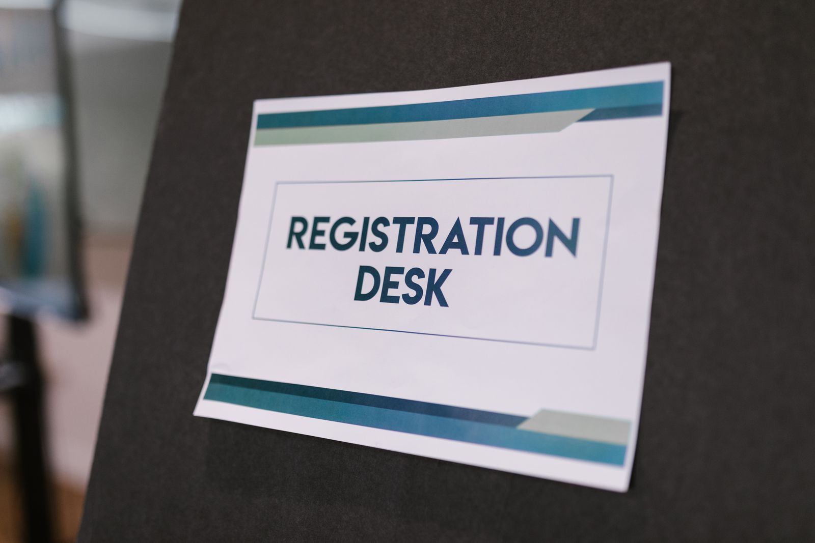 Registration desk sign at a conference, the first post to fill when planning conference staff in Dubai