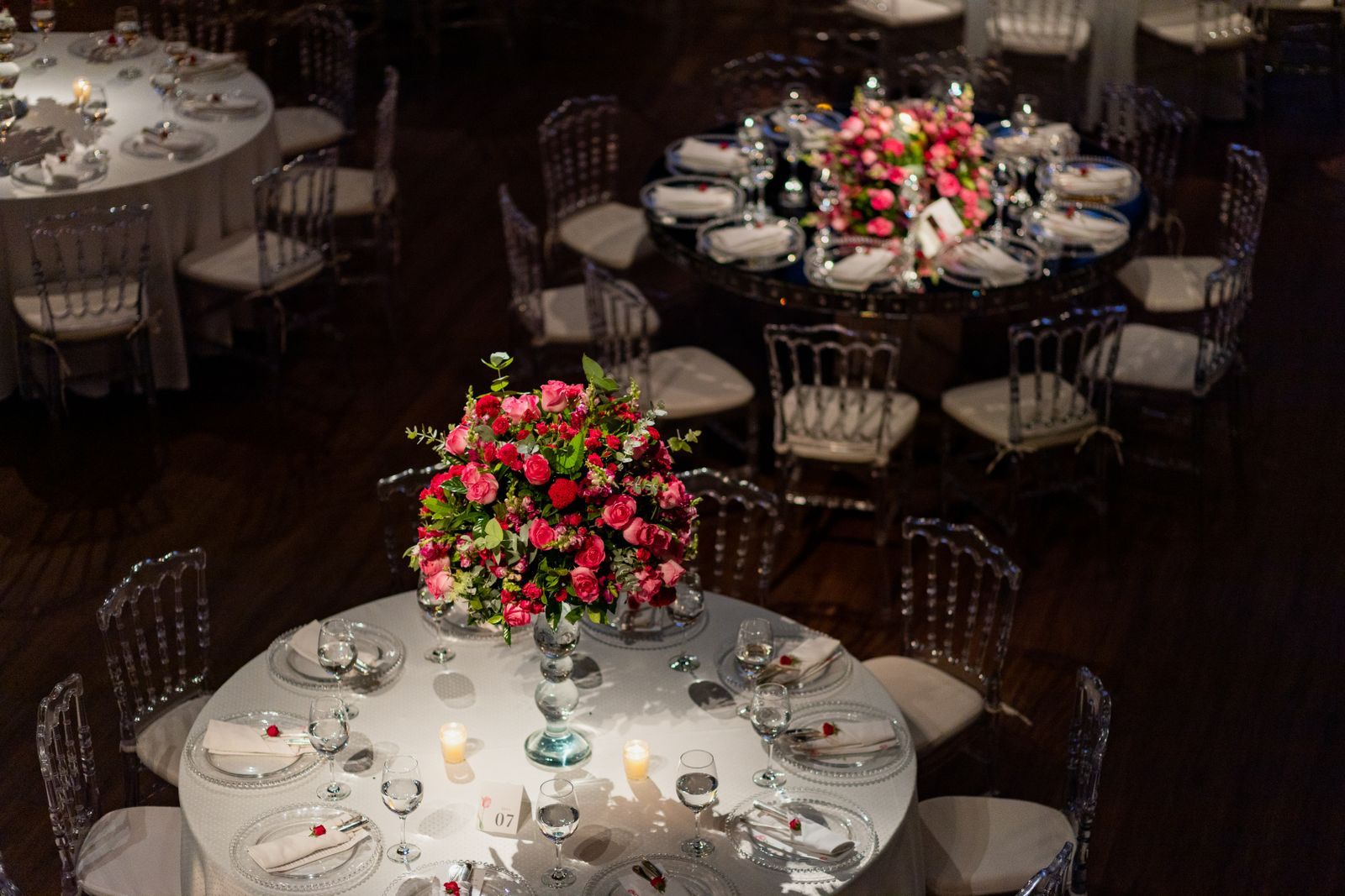 Wedding reception tables set with floral centrepieces, ready for wedding staff in Dubai to welcome guests