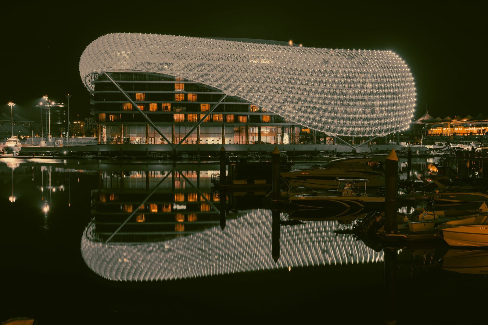 Yas Island hotel and marina lit up at night, where Abu Dhabi Grand Prix event staff host race weekend guests