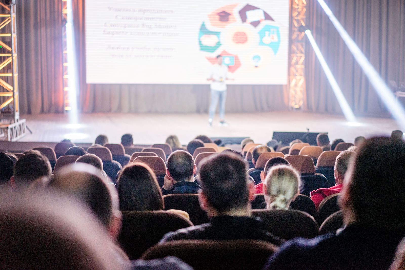 Conference audience watching a presentation in a plenary hall