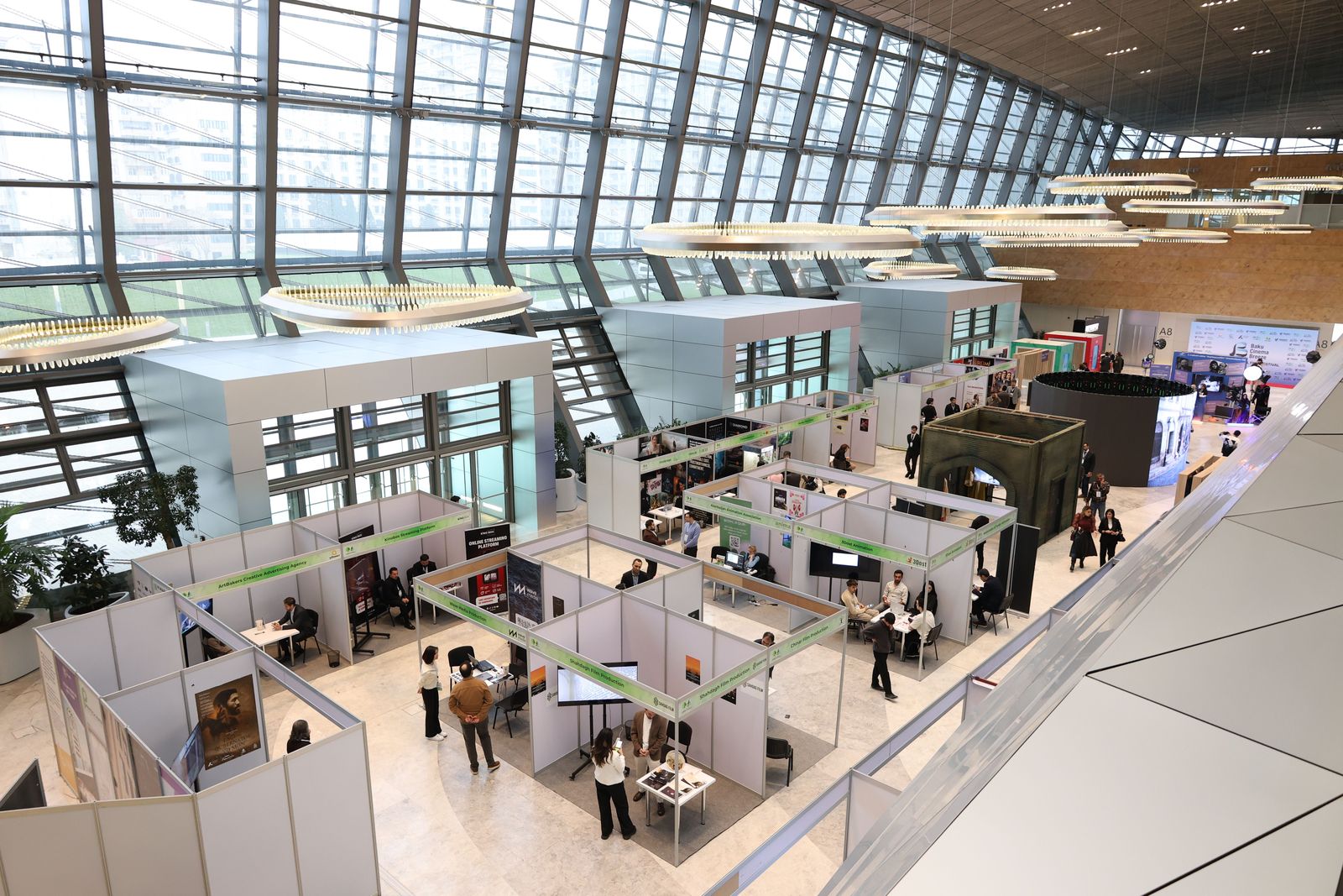 Exhibition hall with rows of stands, seen from above