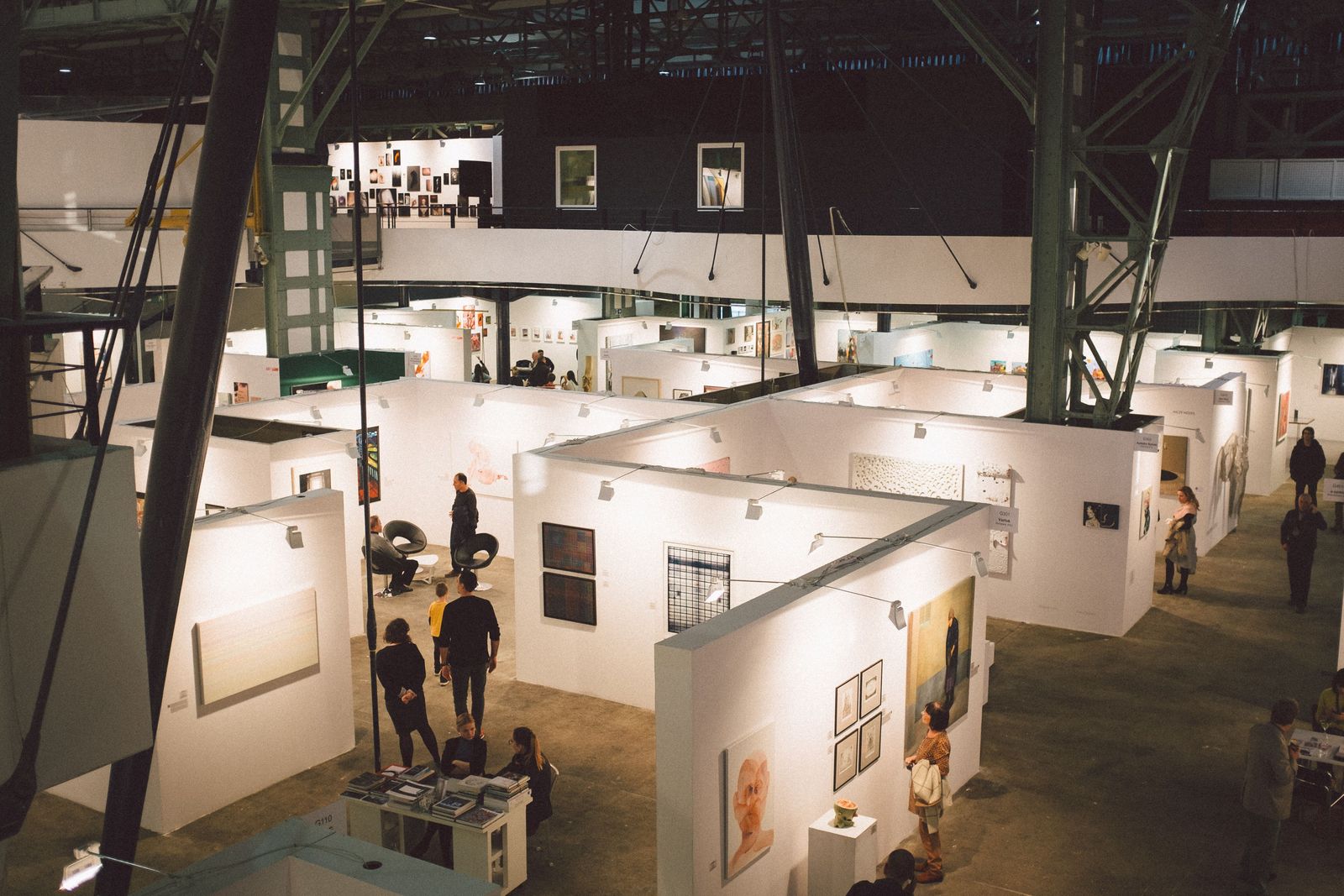 Exhibition stands laid out along the aisles of a large hall