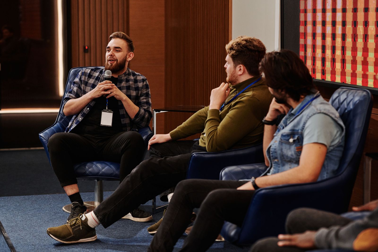 Panel speakers seated on stage during a conference session