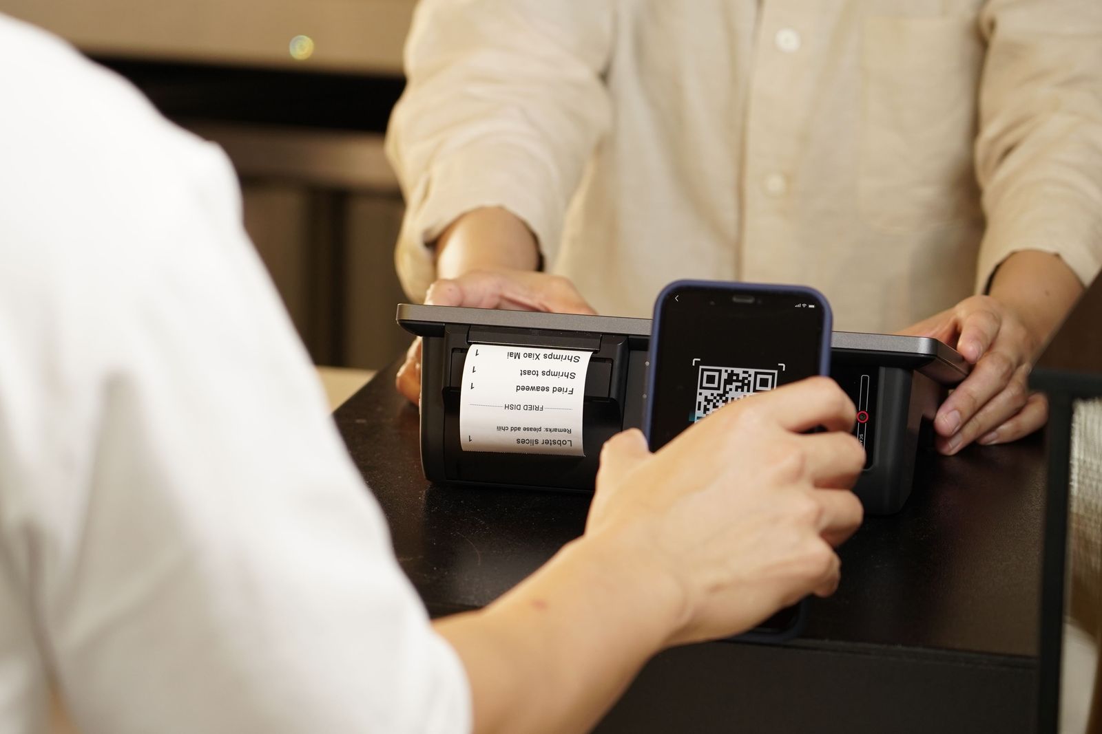 Visitor scanning a QR code at a counter