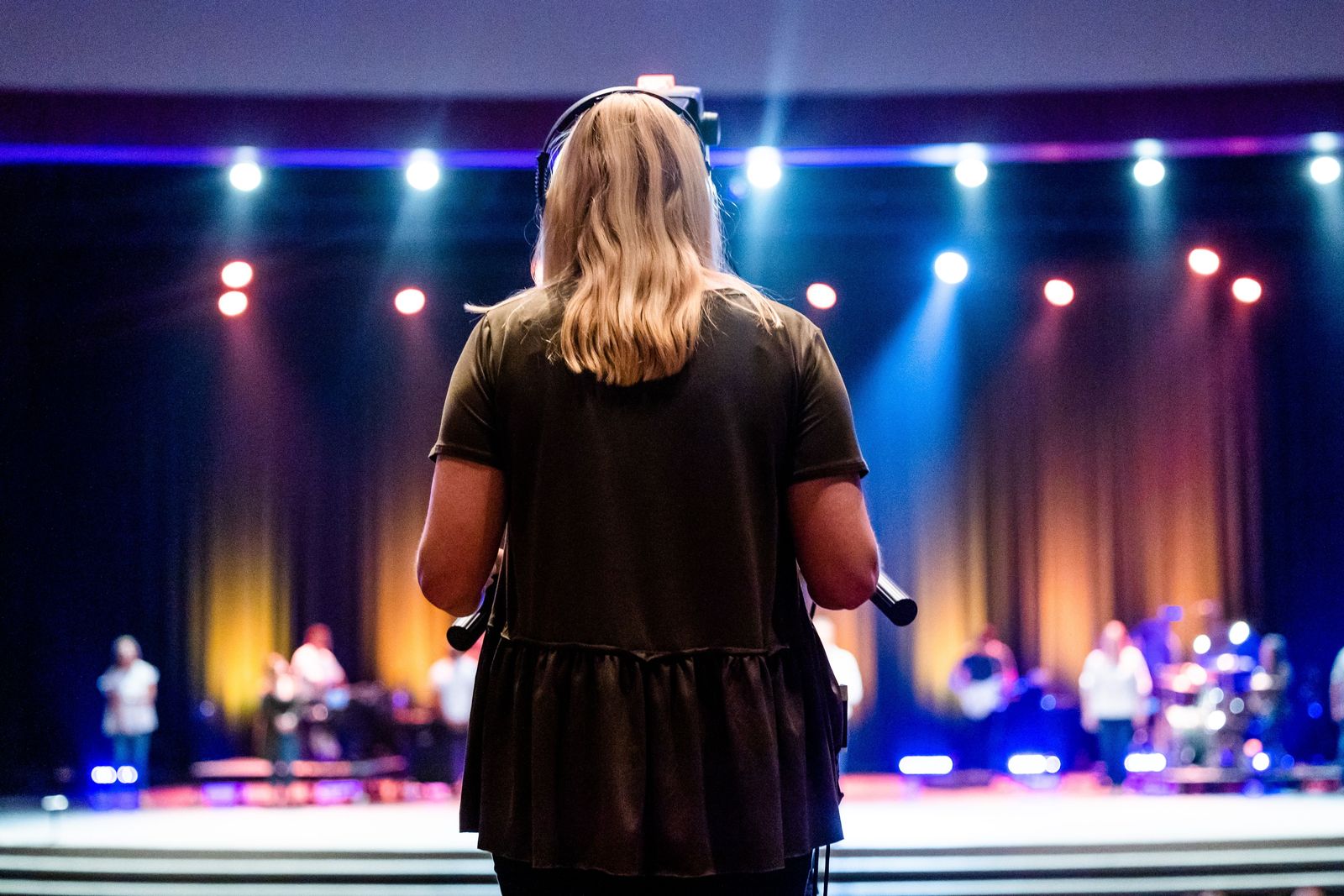 Crew member on headset watching the stage during a live show