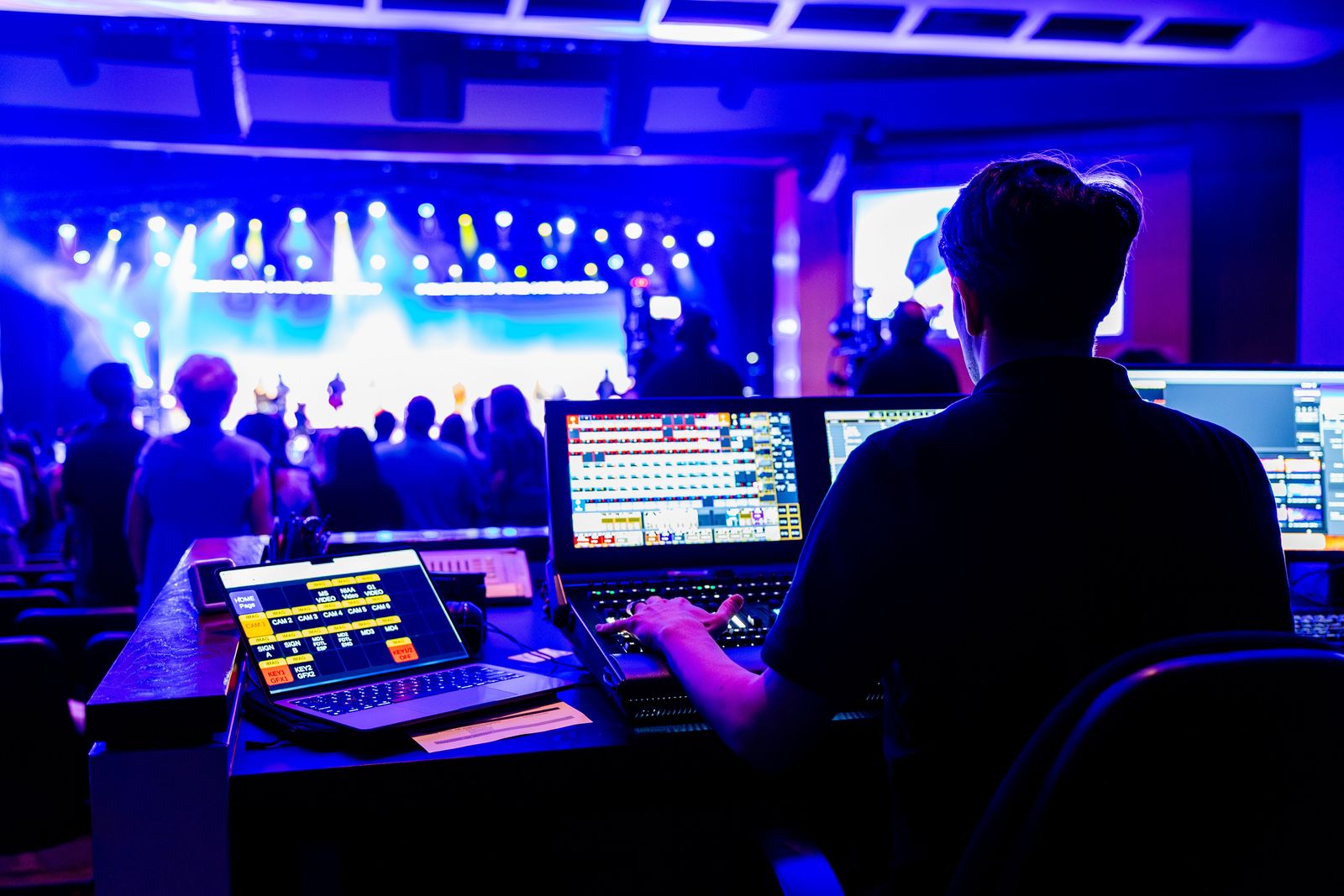Lighting and sound technician at the control desk during a live show