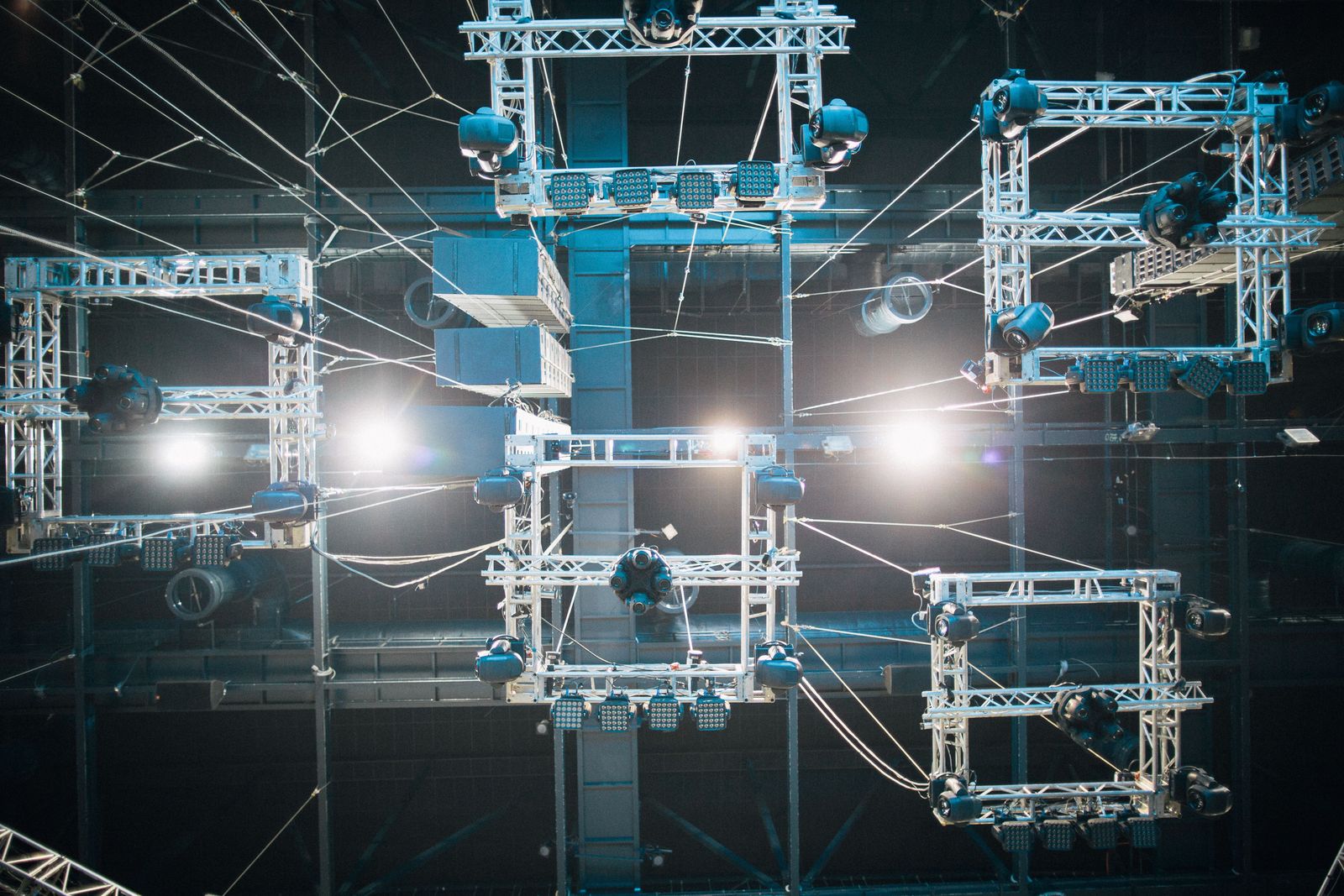 Lighting fixtures rigged on a truss above the stage