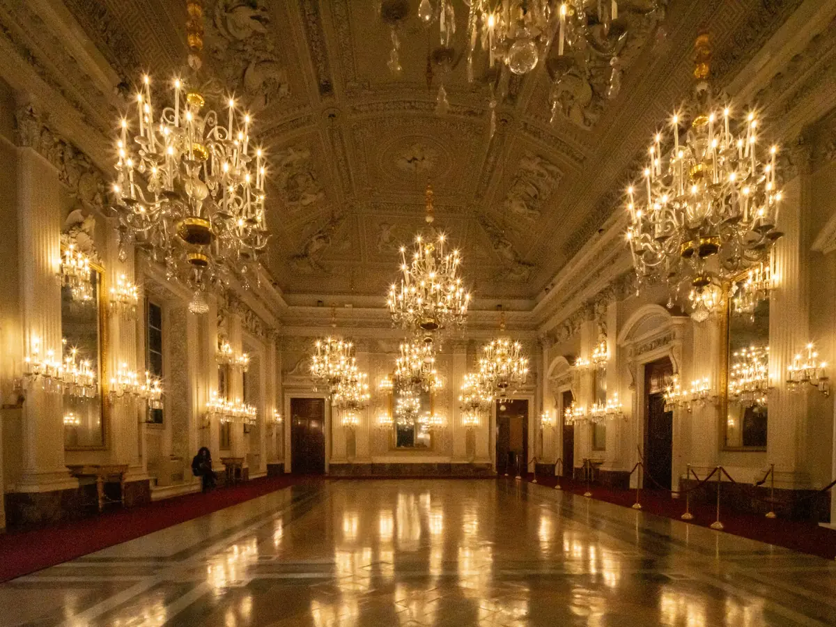 Empty event ballroom lit by crystal chandeliers
